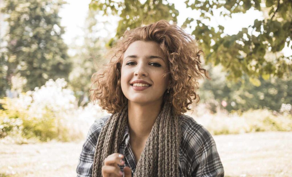 Young adult enjoying clear vision outdoors without glasses after LASIK